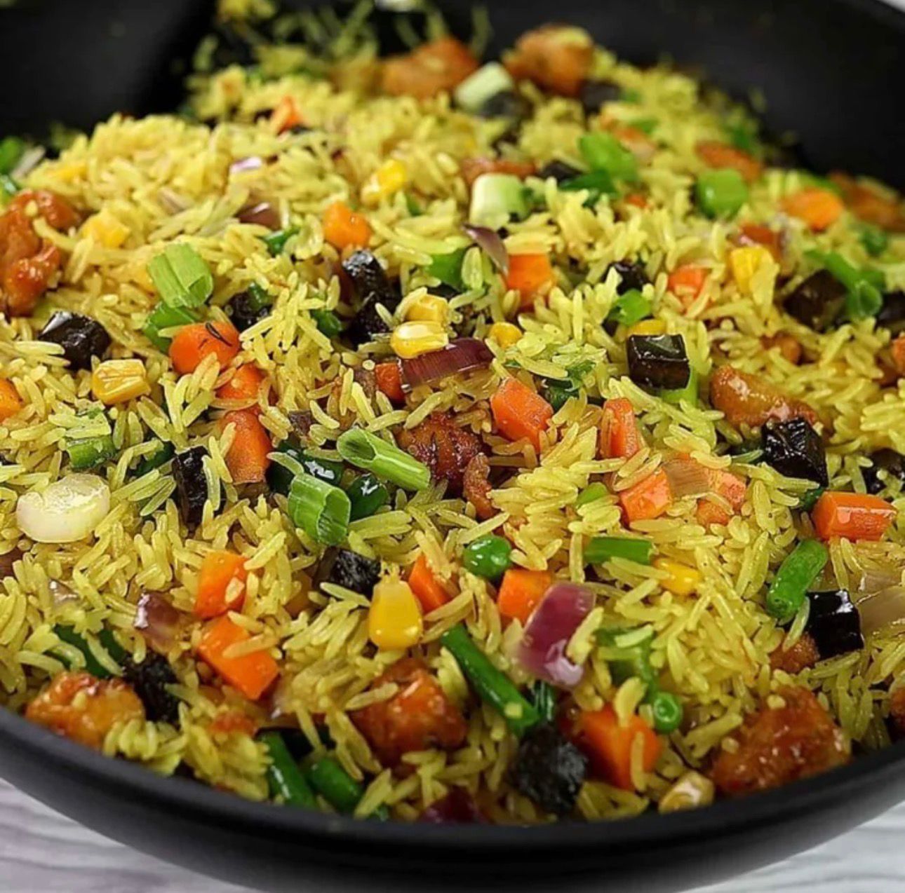 Nigerian fried rice with vegetables and spring onion