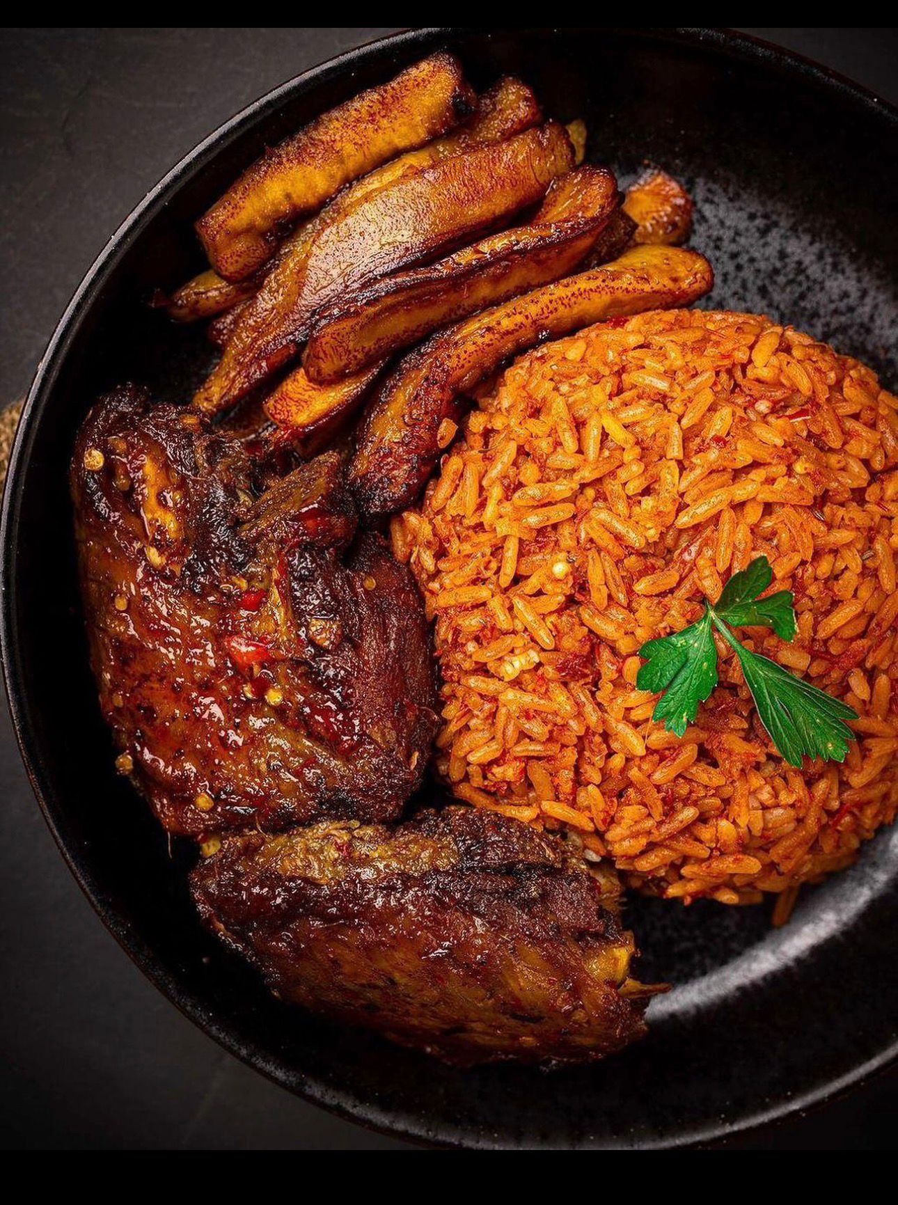 Smoky jollof rice with flame-grilled chicken and fried plantain